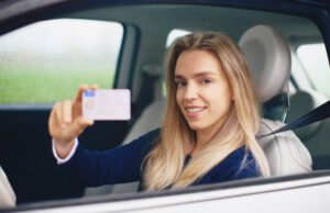 woman or girl smiling with driving license